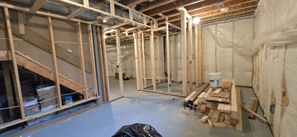 Basement framing, spray foam insulation, and stair opening