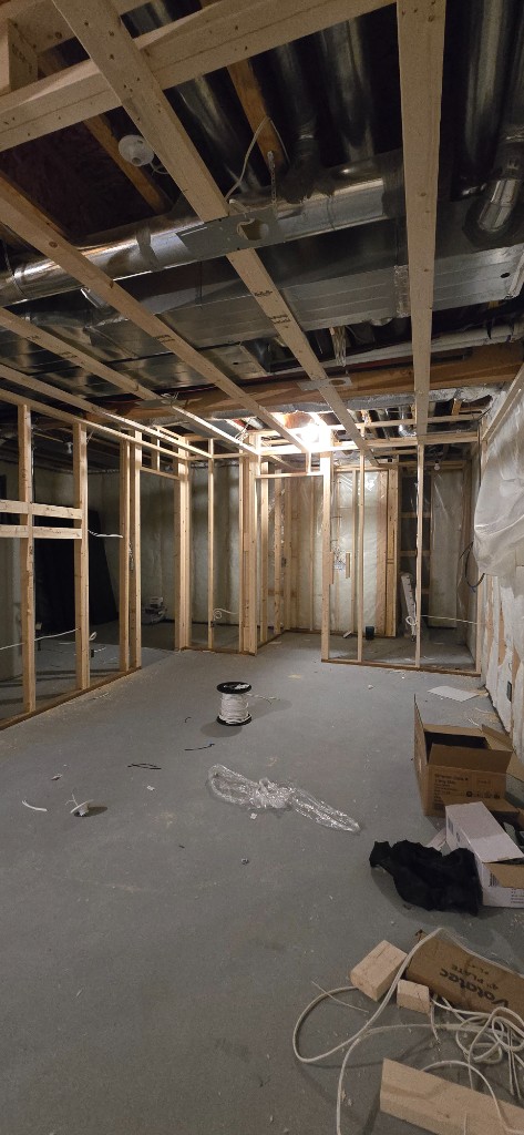 Basement wood framing with HVAC ducts in the ceiling