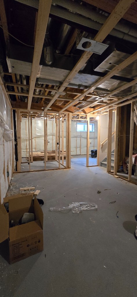 Unfinished basement framing and concrete floor