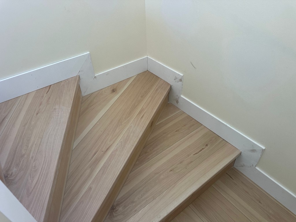 Hardwood winder stairs and baseboard finish