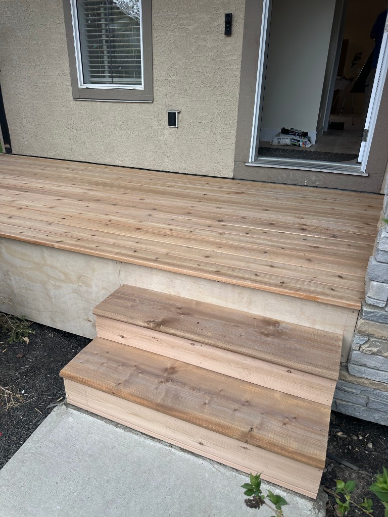 Cedar front landing and stairs at a Calgary home