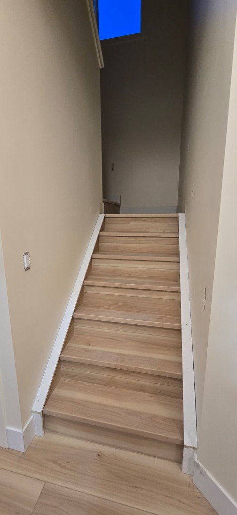 Straight hardwood staircase with painted walls