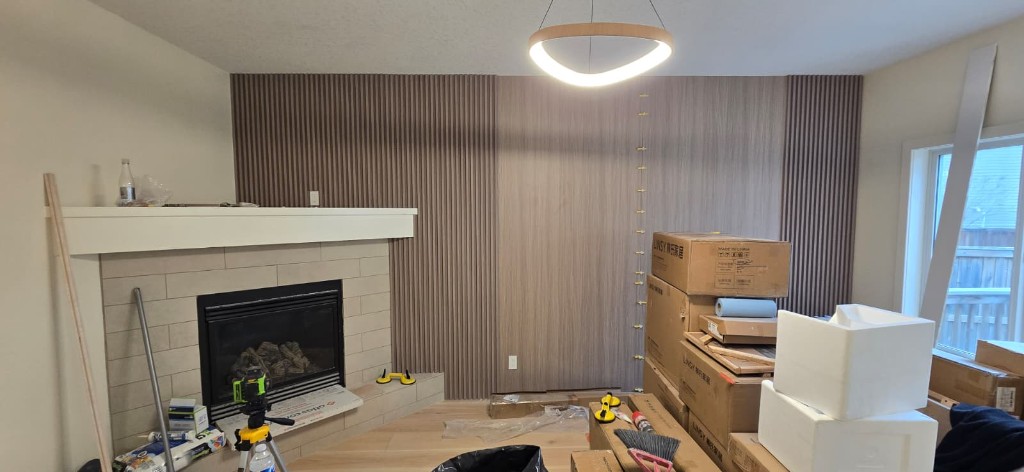 Wood slat feature wall with fireplace during finishing