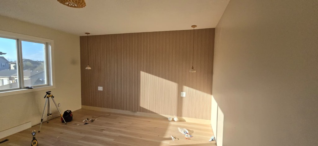 Bedroom wood slat accent wall and pendant lighting