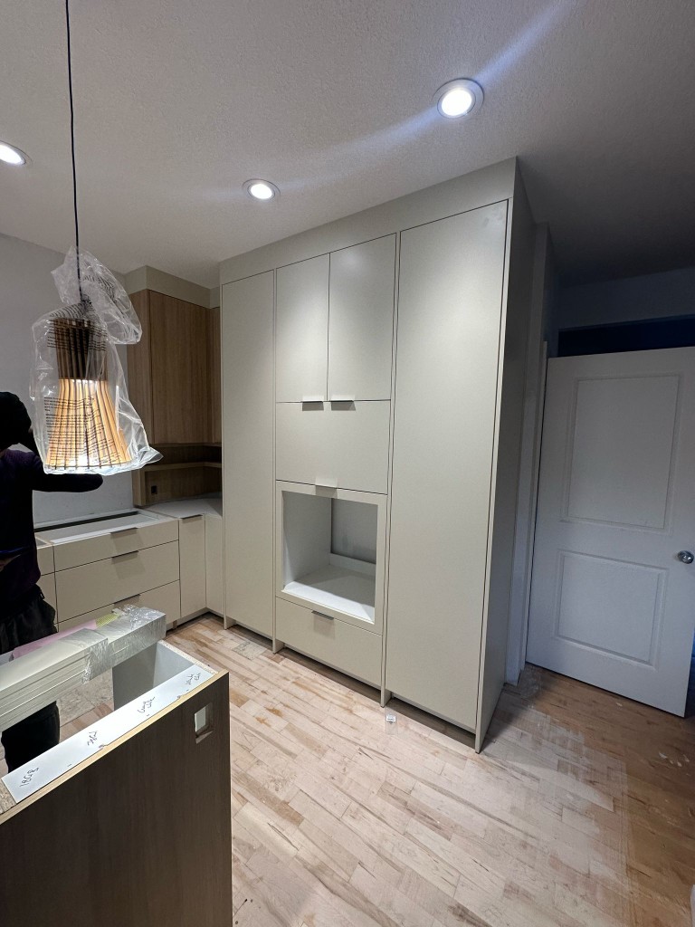Tall custom kitchen cabinet wall with appliance niche
