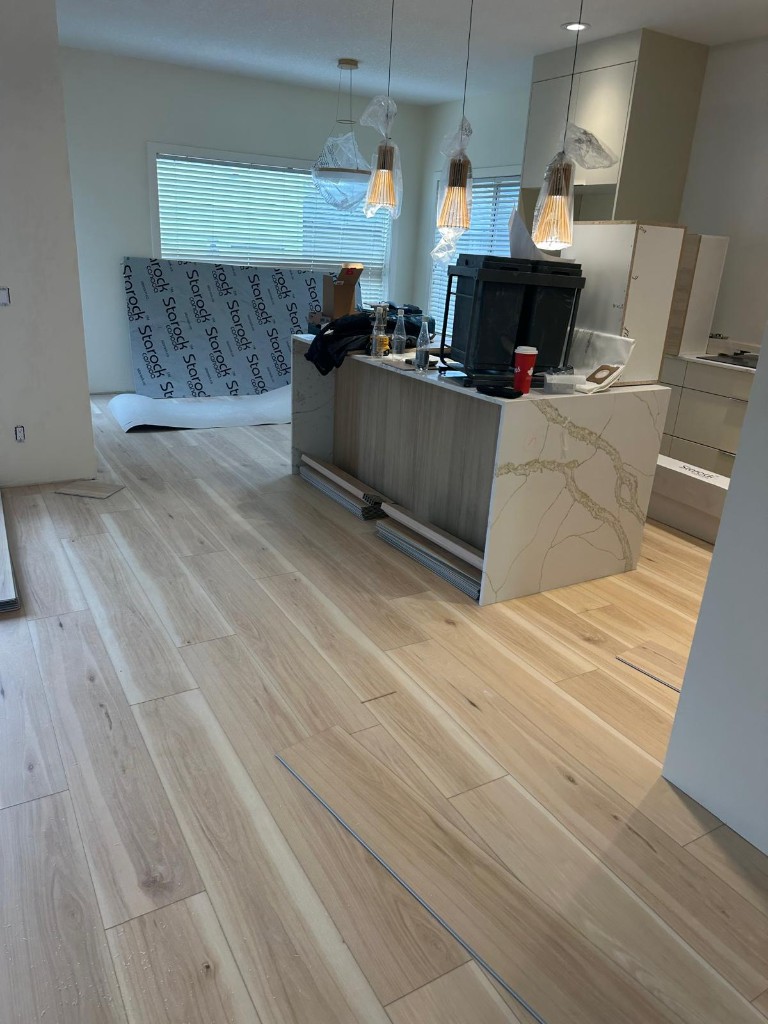 Kitchen island and new hardwood flooring during installation
