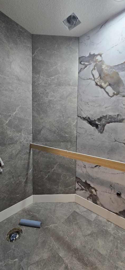 Marble tile shower enclosure during bathroom remodel